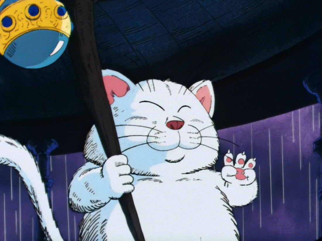 Maître Karin, chat blanc aux yeux clos, tient son bâton où pend une jarre bleue et dorée et lève trois doigts, devant une pluie violette.
